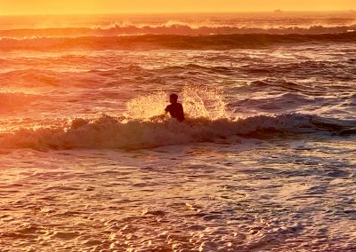 surfer splash in golden light